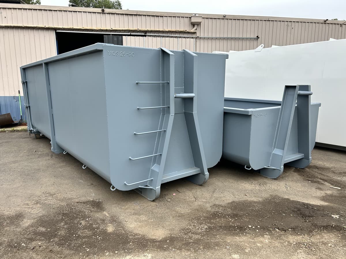 Rolled sided hooklift bins in grey primer